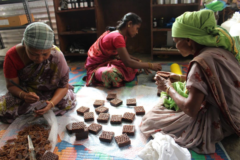 Village women handcrafting beeswax soaps at Last Forest Enterprises